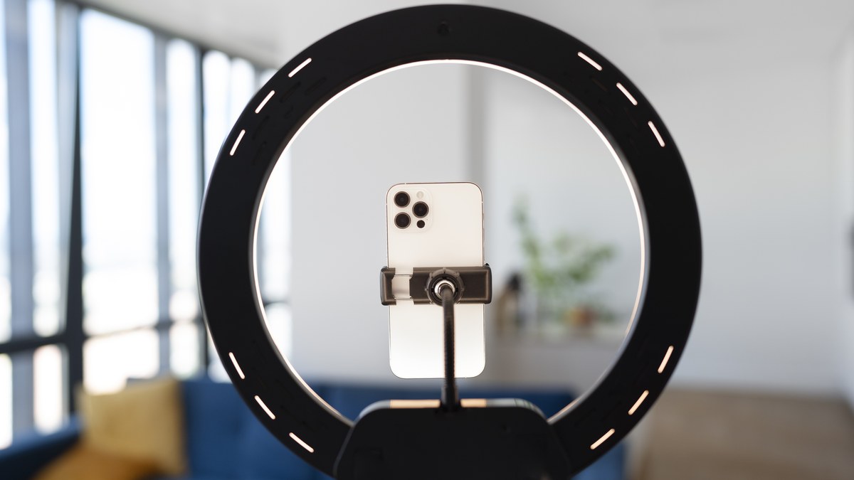 Live streaming studio setup with ring light camera microphone and smartphone ready to broadcast