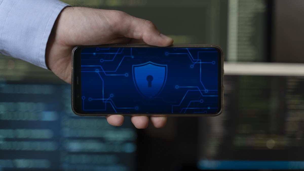 A user holding a smartphone with digital security and lock indicators