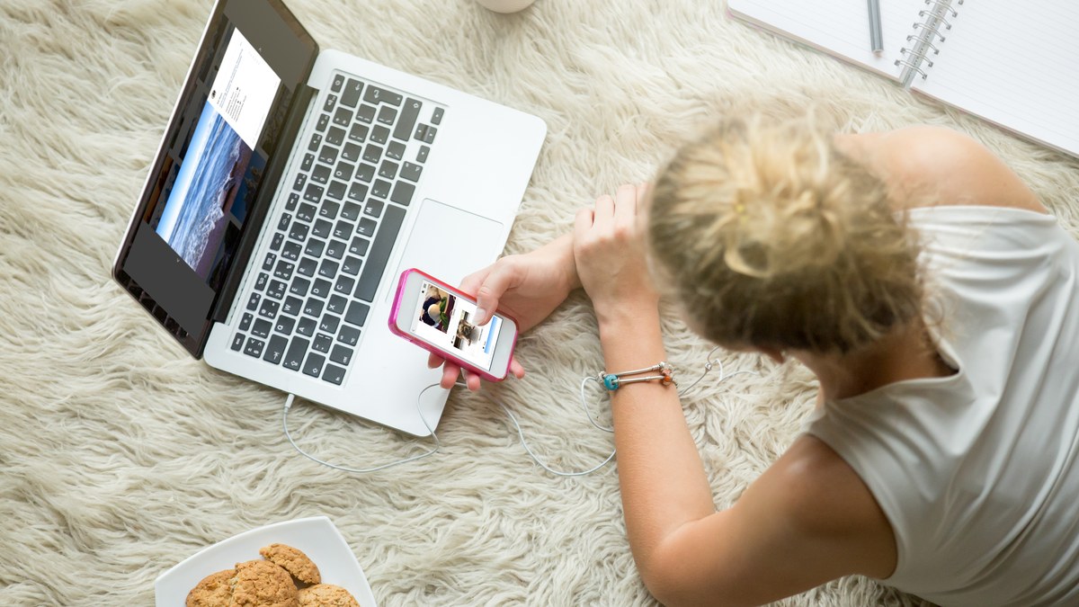 Creator using smartphone to browse mobile social media profiles