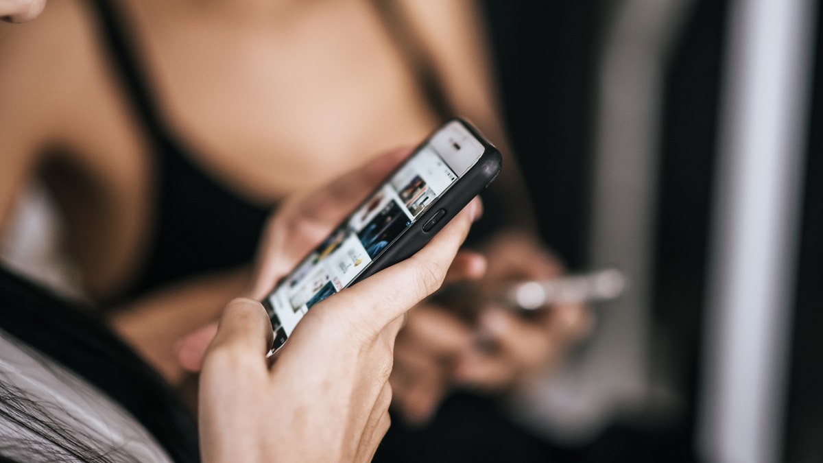 Smartphone displaying quick switching between Instagram feed and Telegram broadcast channel