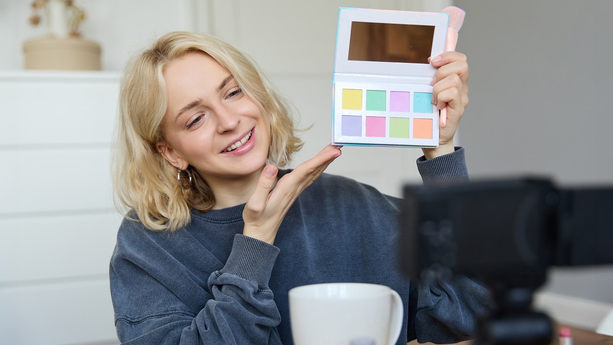 Stylish woman browsing pinterest visual moodboard and messaging customer on smartphone