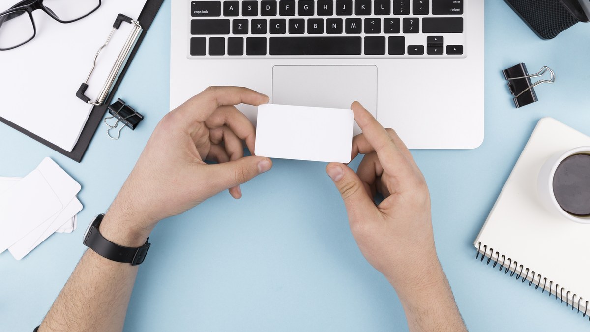 Designer holding a minimalist luxury business card with a crisp printed dynamic QR code