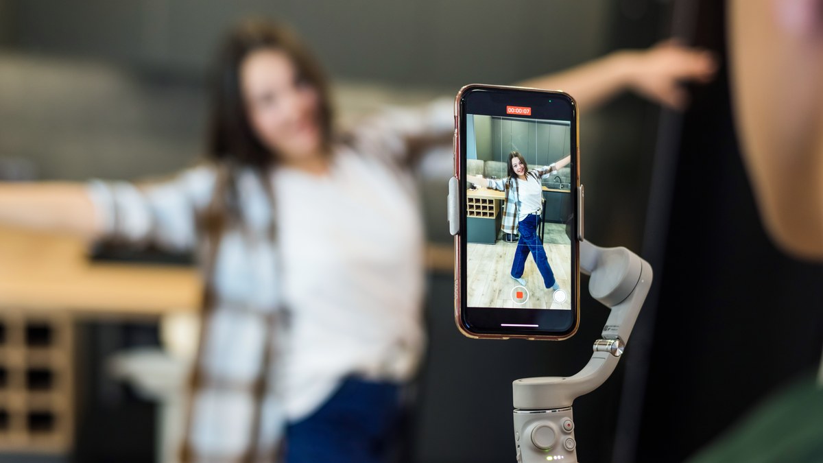 Smartphone screen showing a minimalist influencer link in bio landing page with clean buttons