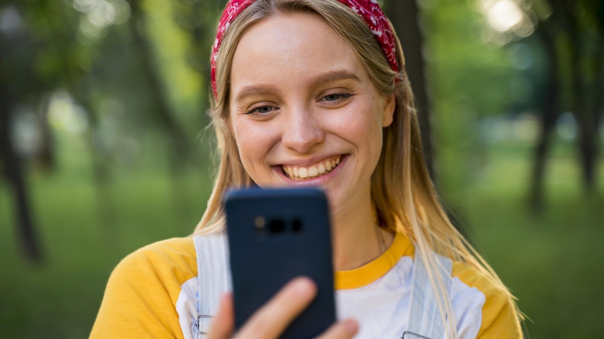 Yellow branded Snapchat display on mobile phone with user profile avatar and scannable Snapcode icon