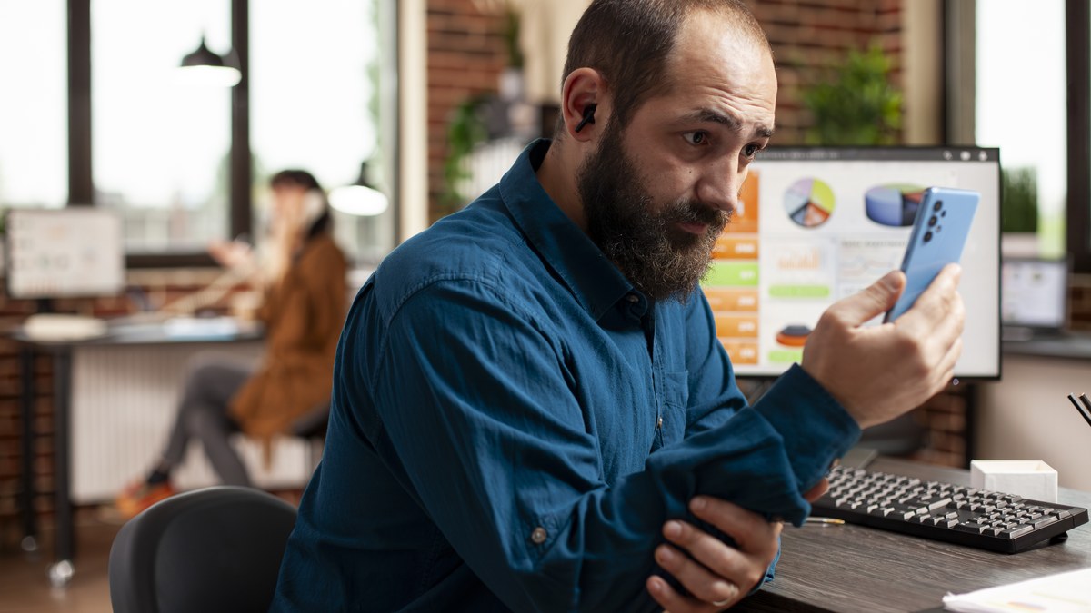 Marketer examining Telegram channel analytics and subscriber conversion graphs on laptop screen