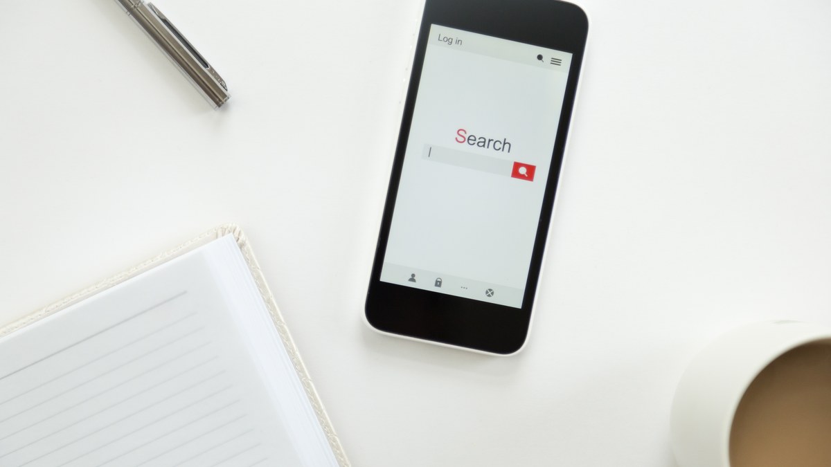 Mobile smartphone showing YouTube video player on a desk